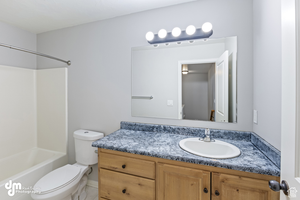 Full bathroom featuring tile flooring, bathtub / shower combination, vanity, and toilet