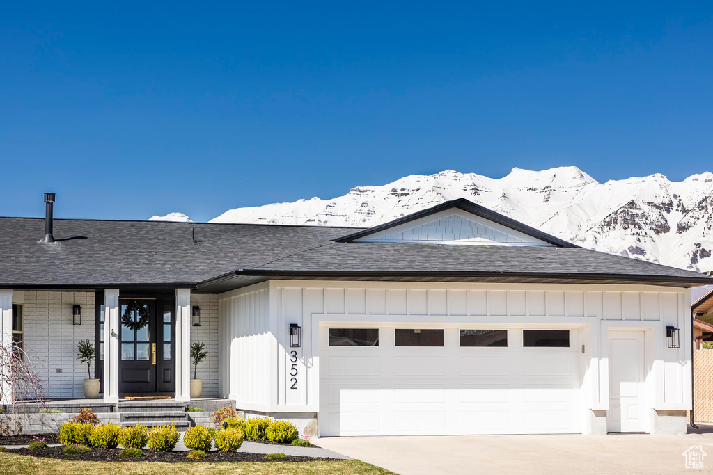 Ranch-style home featuring a mountain view and a garage