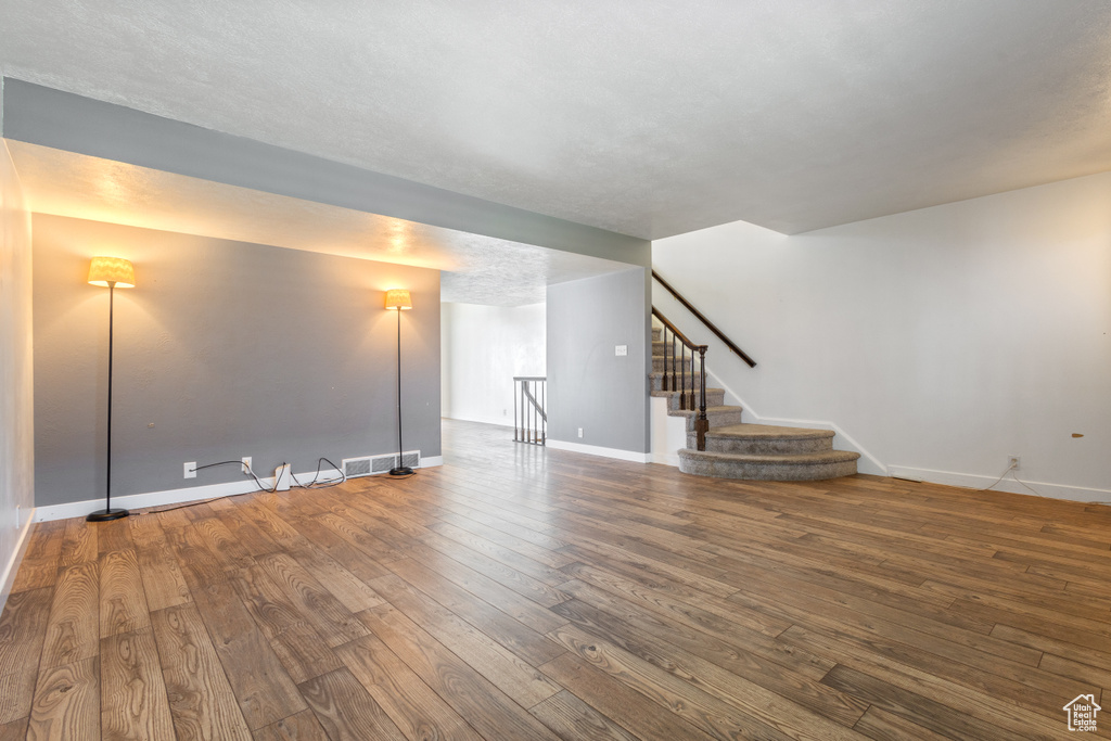 Basement featuring dark hardwood / wood-style flooring