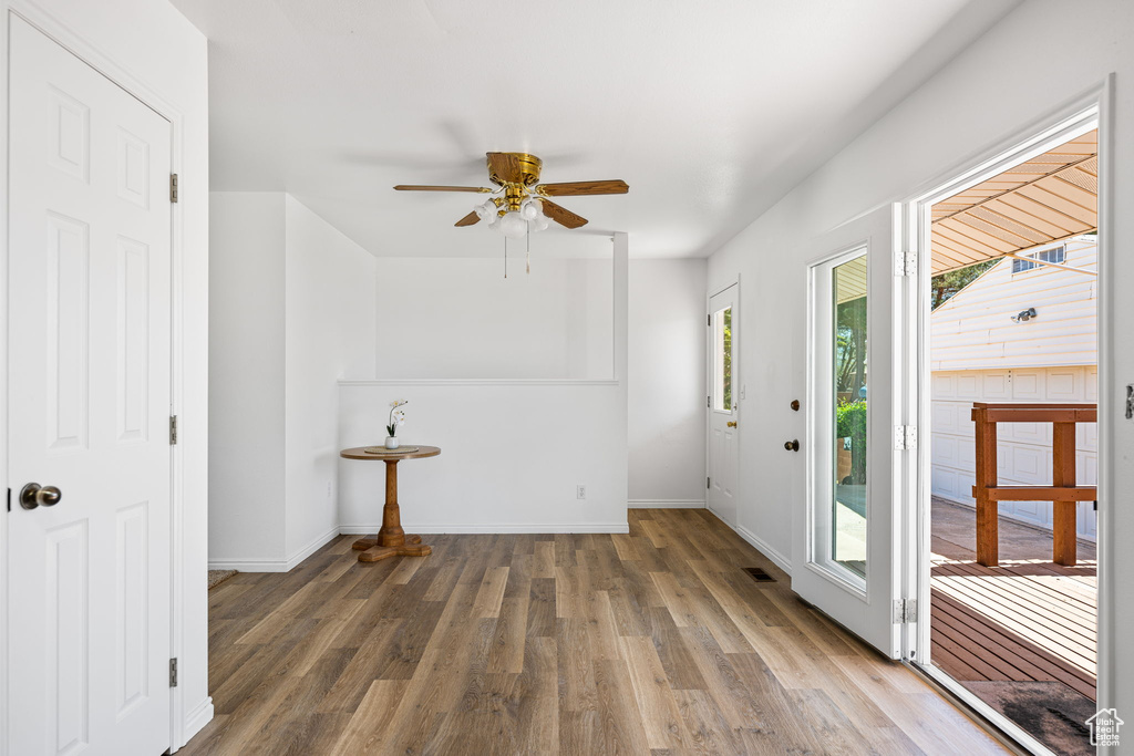 Foyer with dark hardwood / wood-style floors and ceiling fan