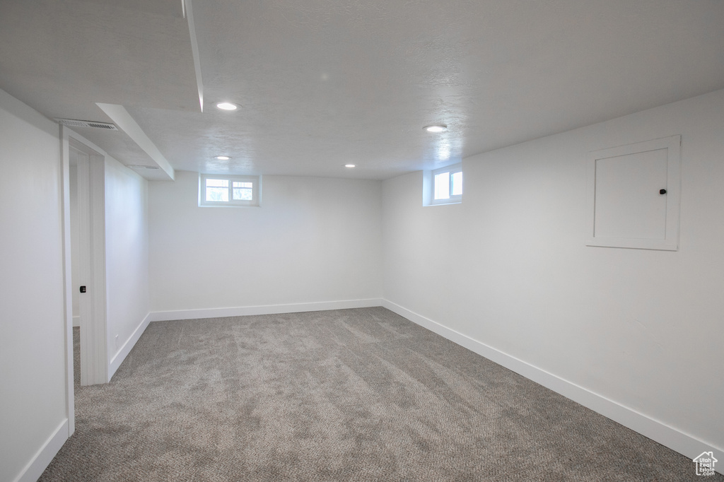 Basement featuring a healthy amount of sunlight and carpet floors