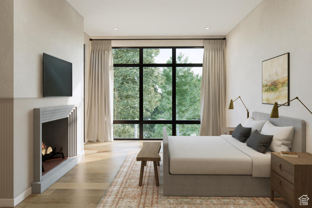 Bedroom with light hardwood / wood-style flooring and multiple windows