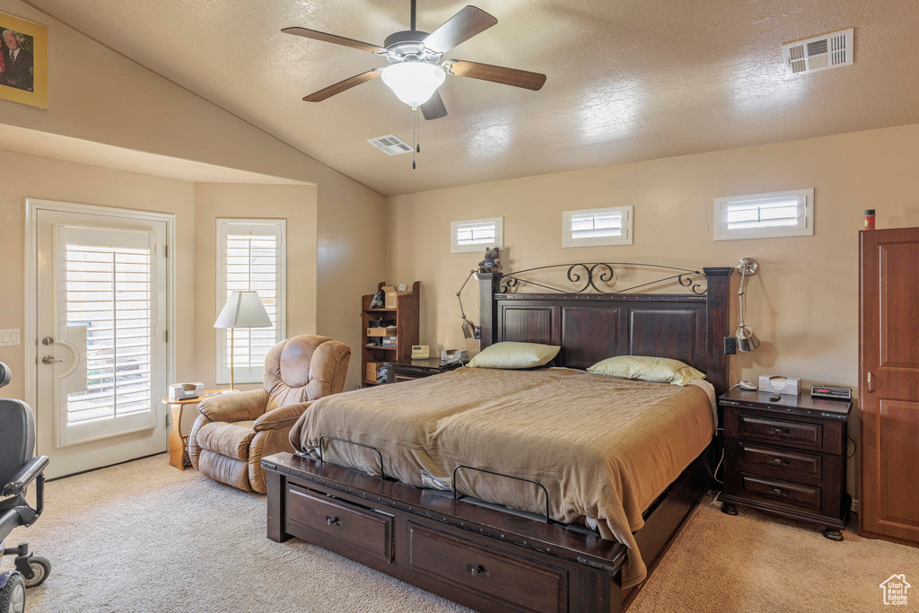 Bedroom featuring light colored carpet, ceiling fan, and multiple windows