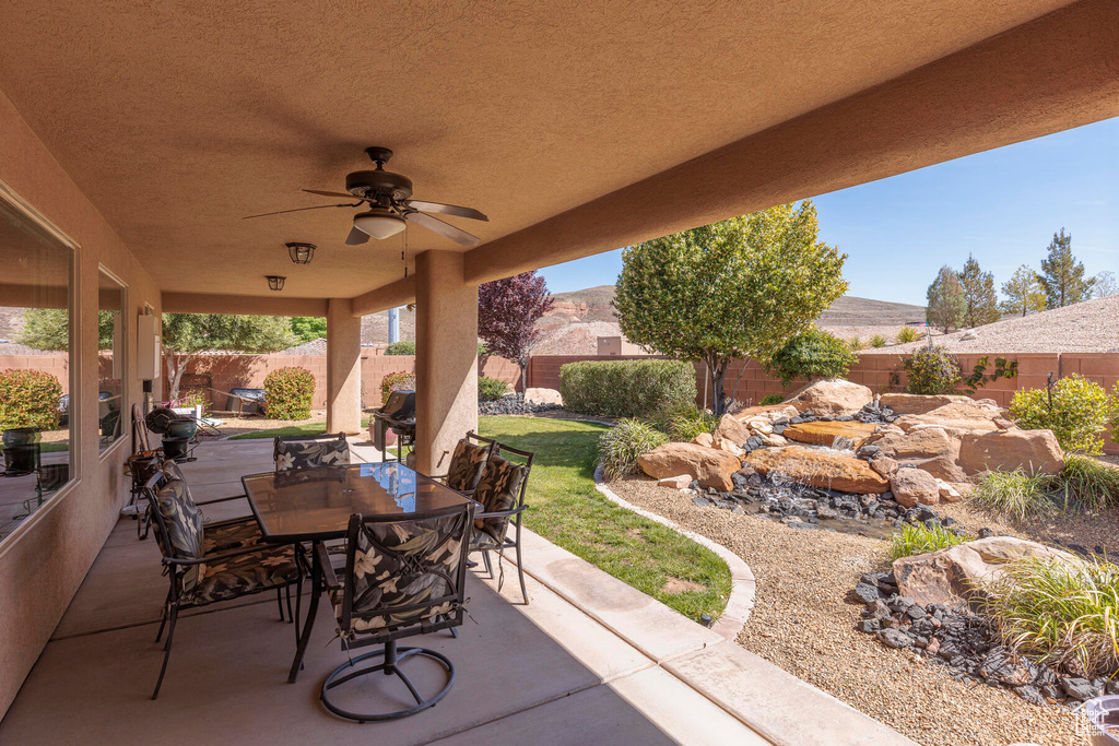 View of patio featuring ceiling fan and a mountain view