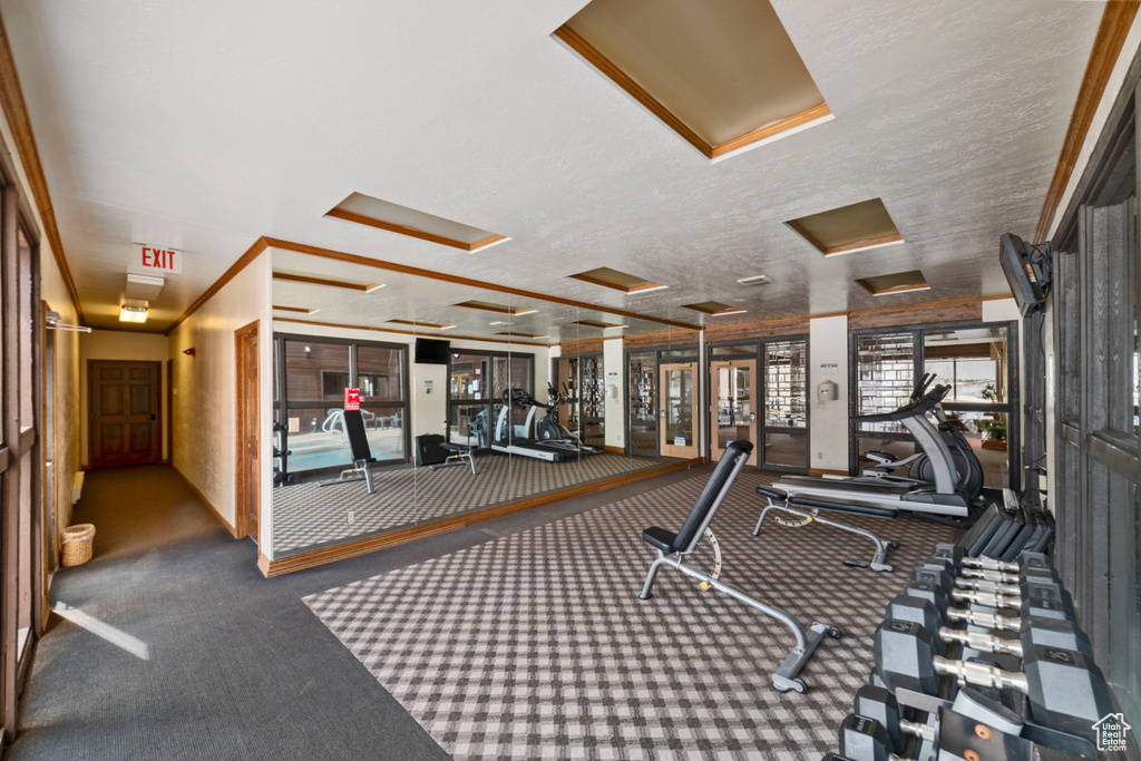 Exercise room with a textured ceiling and dark carpet