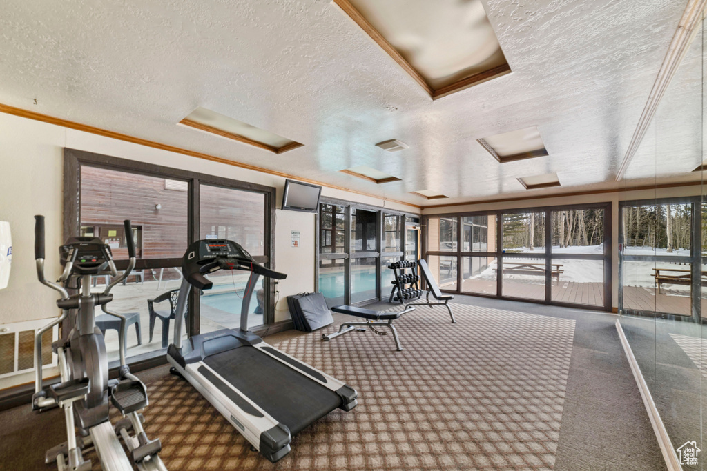 Gym featuring a textured ceiling