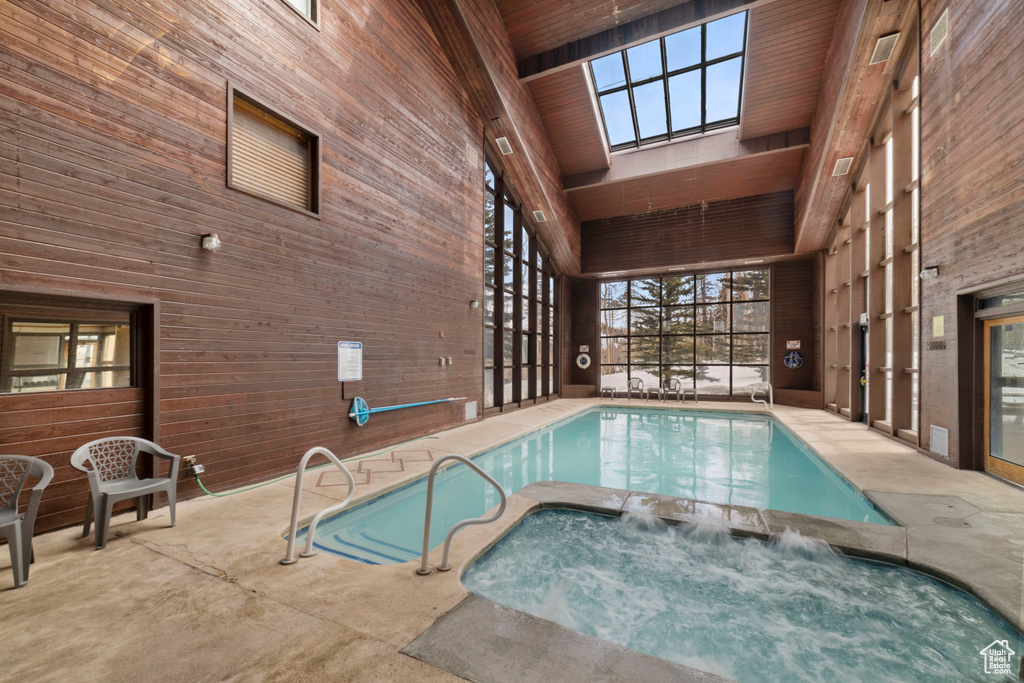 View of pool featuring a patio and an indoor in ground hot tub