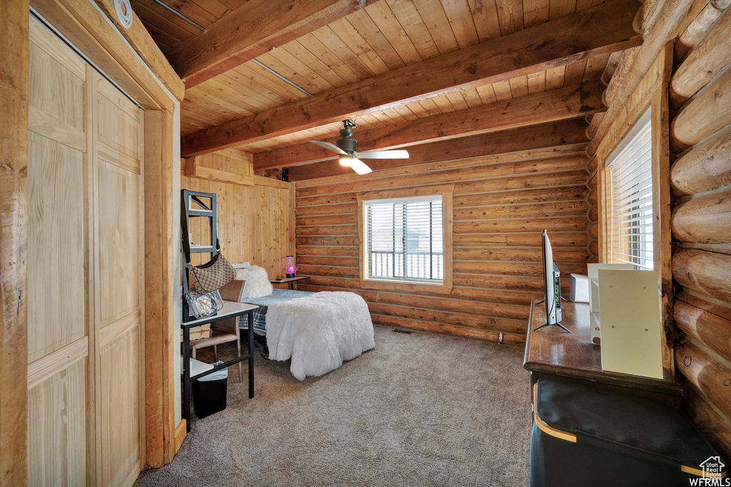 Unfurnished bedroom featuring wooden ceiling, dark colored carpet, and rustic walls