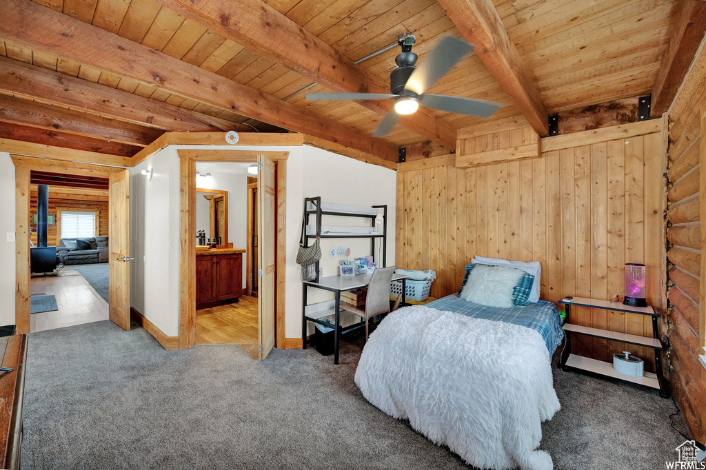 Bedroom with carpet, beamed ceiling, and wooden ceiling