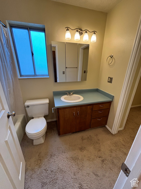 Full bathroom featuring shower / tub combo, vanity, toilet, and a textured ceiling