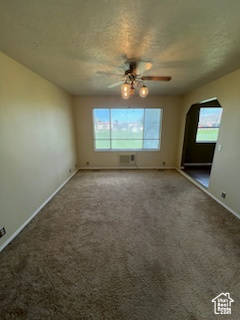 Empty room with ceiling fan, a healthy amount of sunlight, and carpet floors