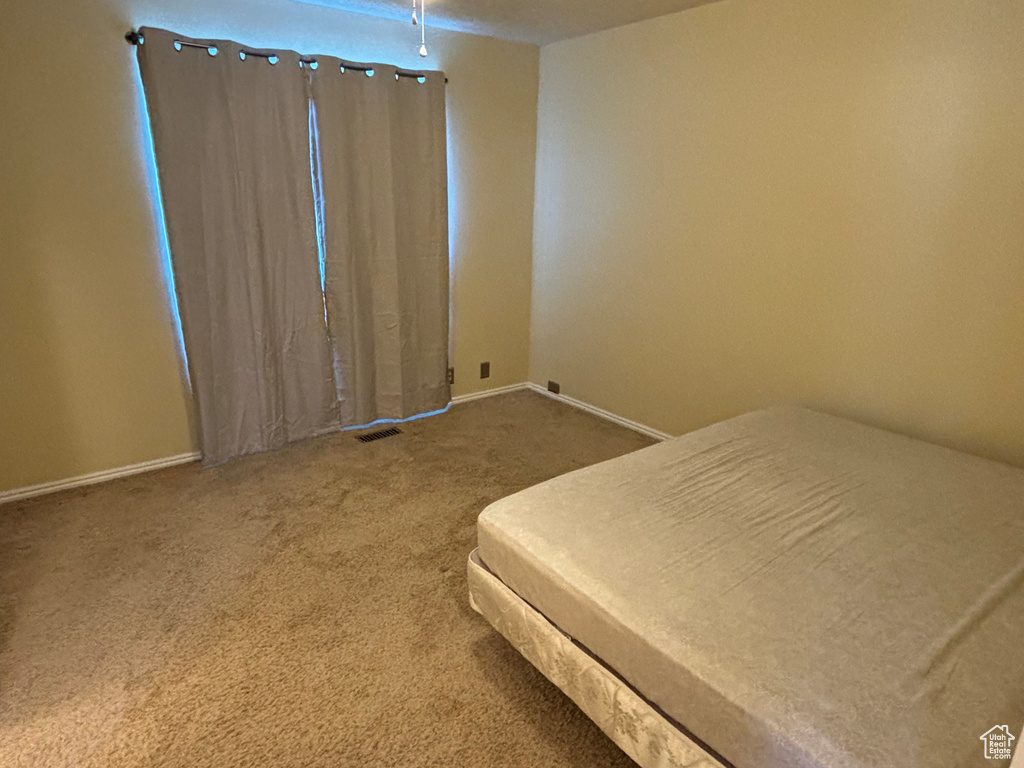 Unfurnished bedroom with carpet