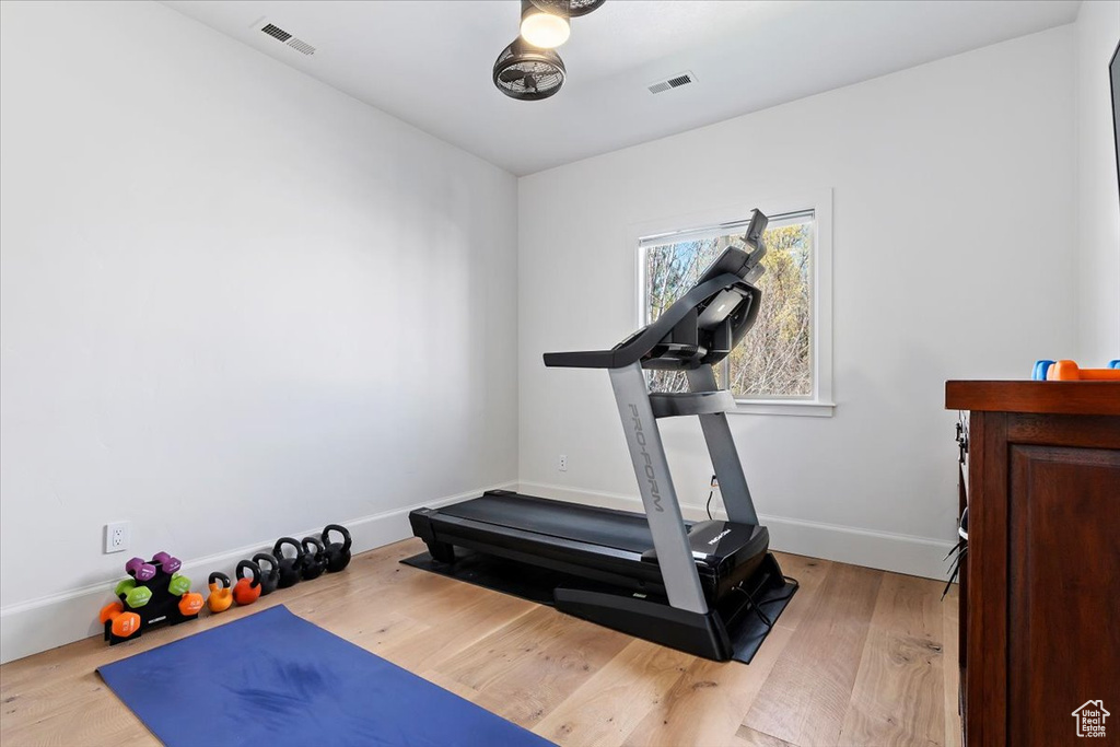 Workout area with light wood-type flooring