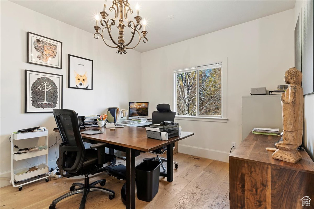 Office area featuring light hardwood / wood-style flooring and a notable chandelier