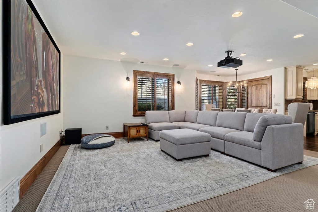 Living room with an inviting chandelier and carpet