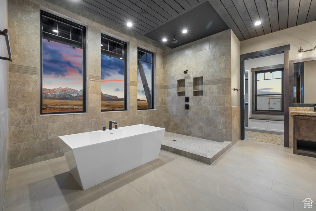 Bathroom featuring tile walls, large vanity, tile floors, wooden ceiling, and plus walk in shower