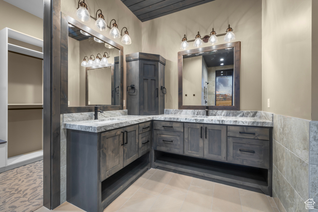 Bathroom featuring oversized vanity, tile floors, and double sink