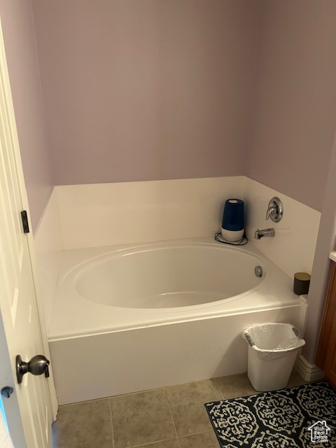 Bathroom featuring a washtub and tile flooring