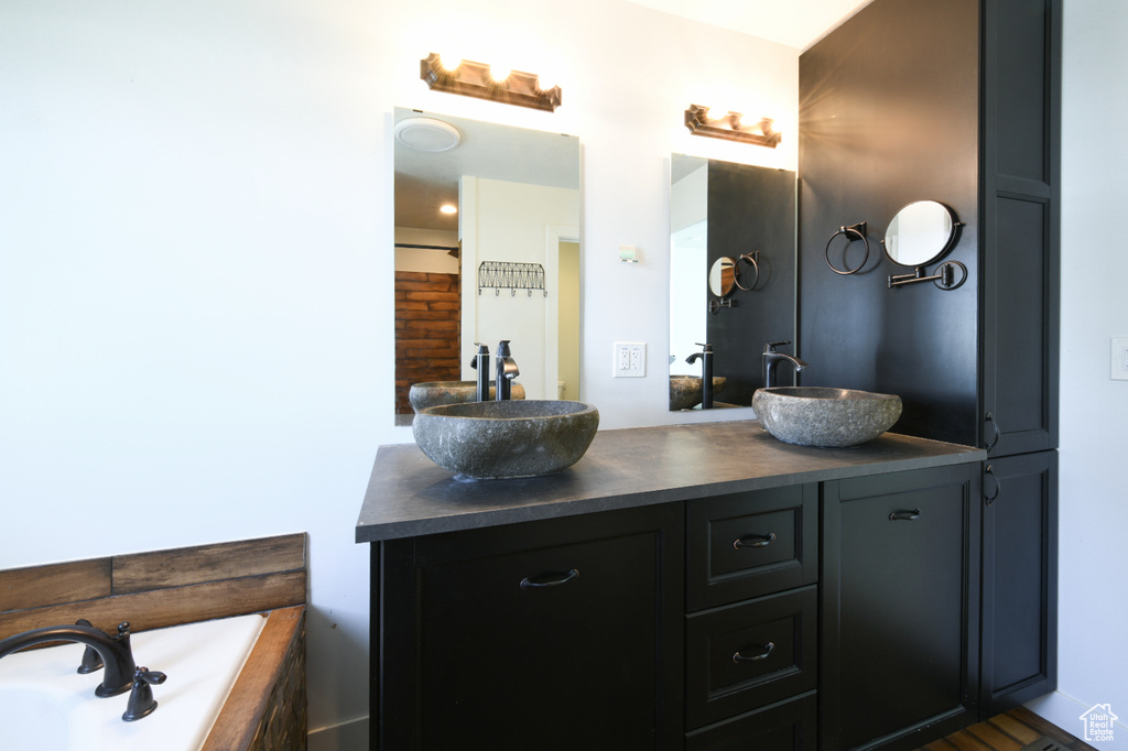 Bathroom with double vanity and a tub
