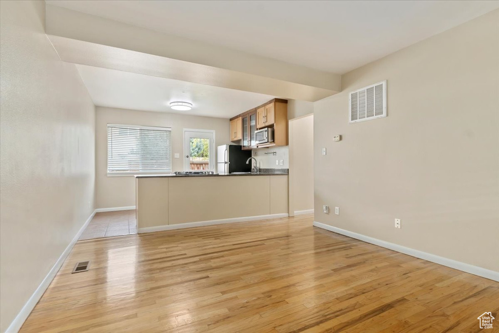 Interior space with light hardwood / wood-style floors and sink