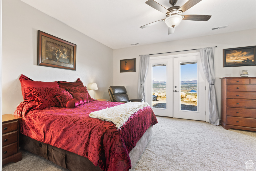 Carpeted bedroom with ceiling fan, access to exterior, and french doors