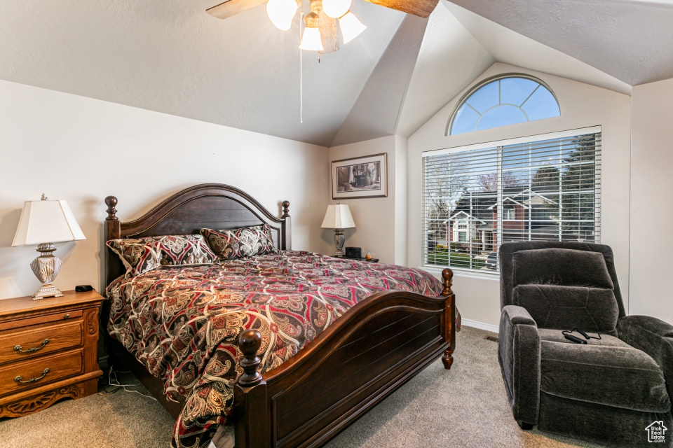 Bedroom featuring carpet flooring, ceiling fan, and vaulted ceiling