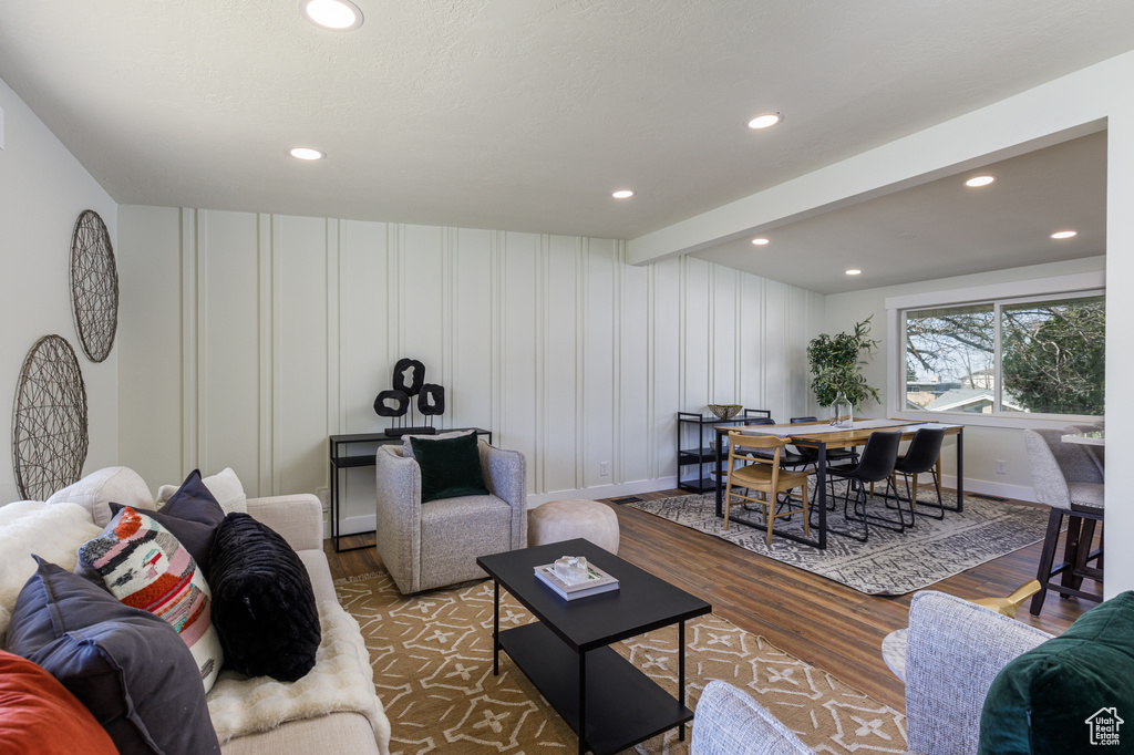Living room featuring dark hardwood / wood-style floors and beam ceiling