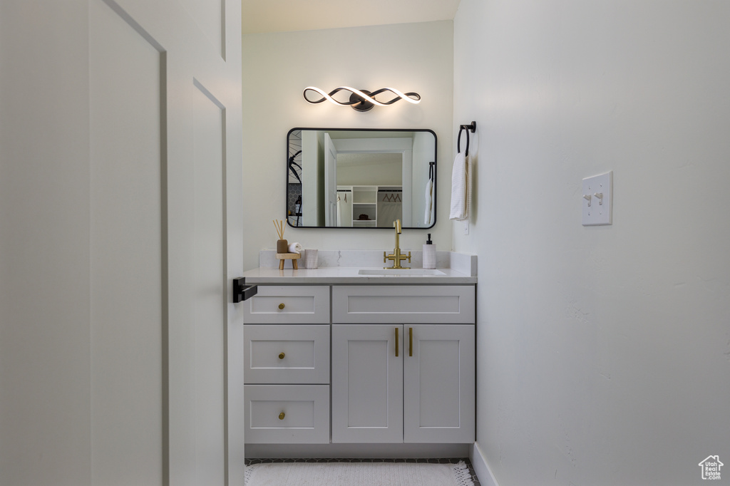 Bathroom with large vanity and tile flooring