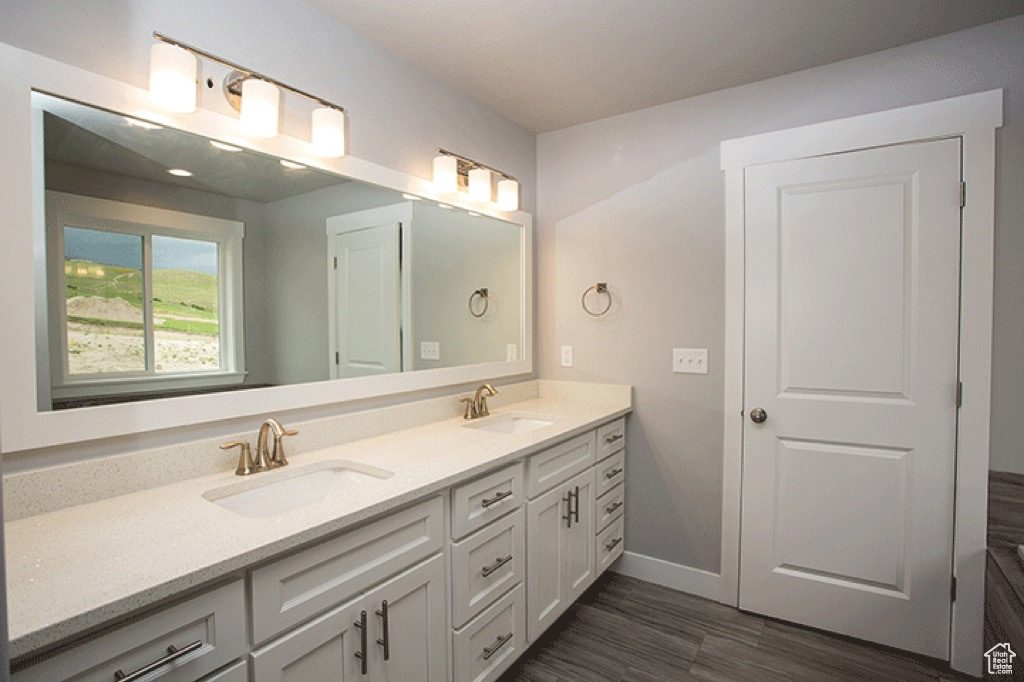 Bathroom with dual sinks and vanity with extensive cabinet space
