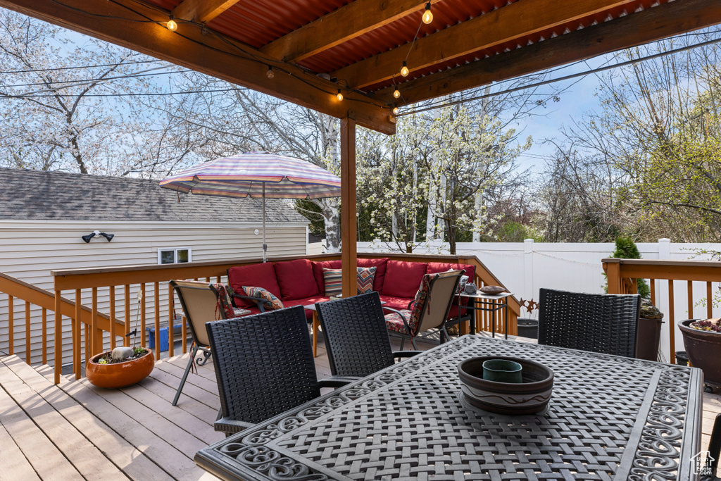 Wooden deck featuring an outdoor living space