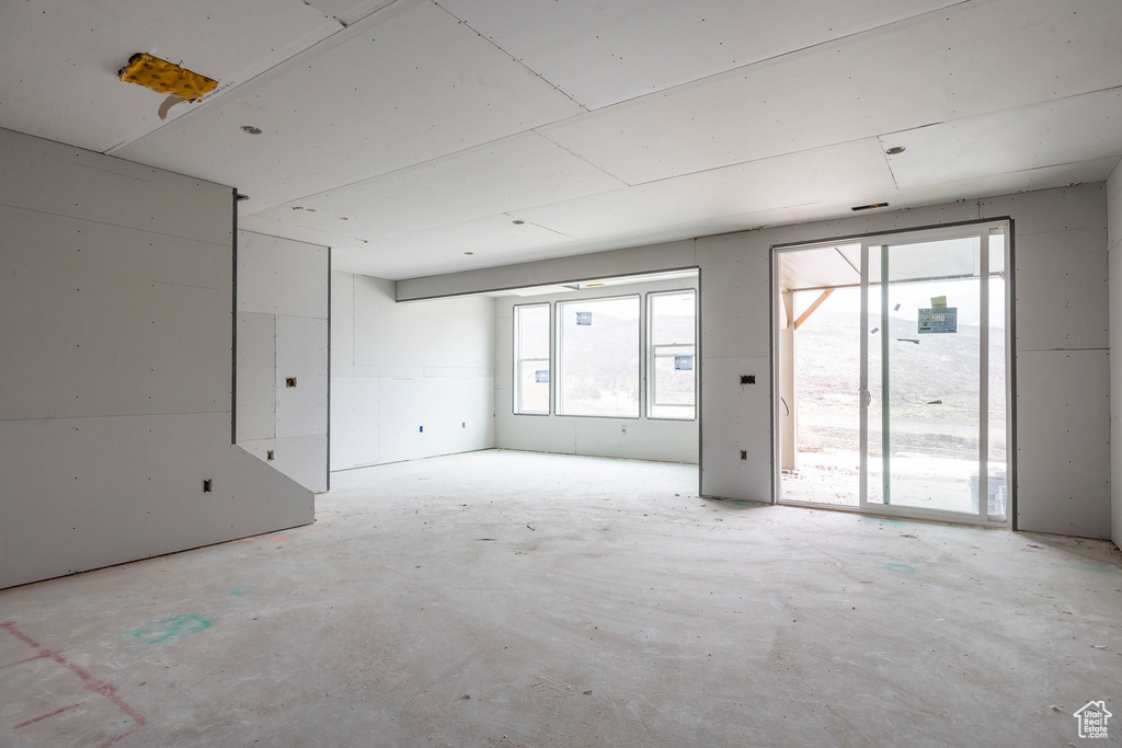 Empty room featuring unfinished concrete floors