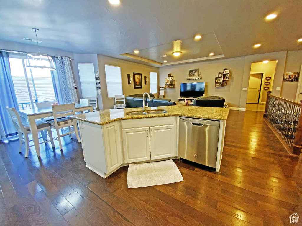 Kitchen featuring sink, dark hardwood / wood-style flooring, stainless steel dishwasher, and light stone countertops