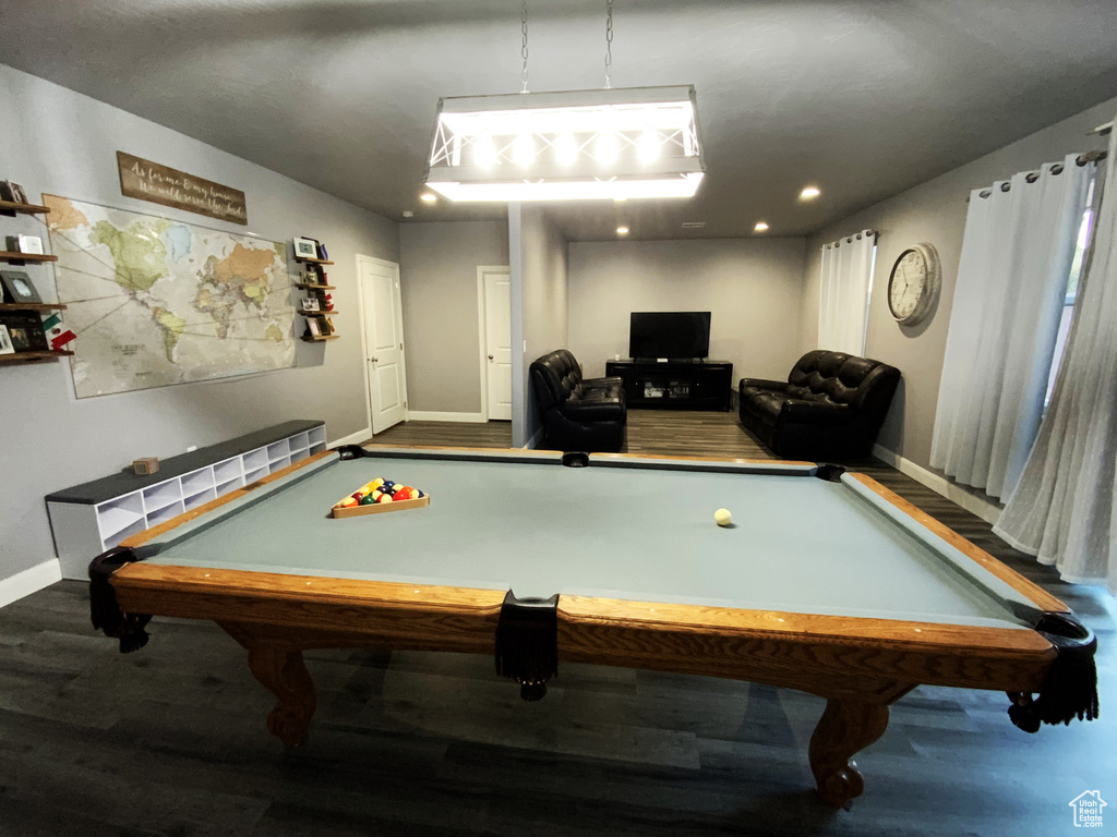 Game room featuring dark hardwood / wood-style floors and billiards