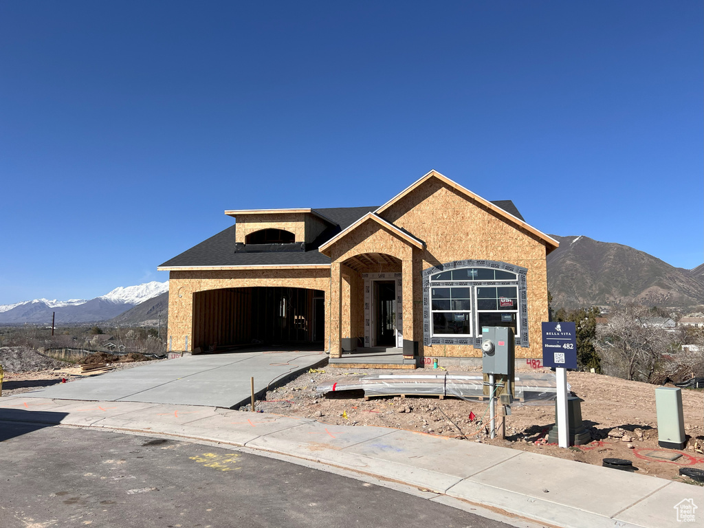 Property in mid-construction with a mountain view and a garage