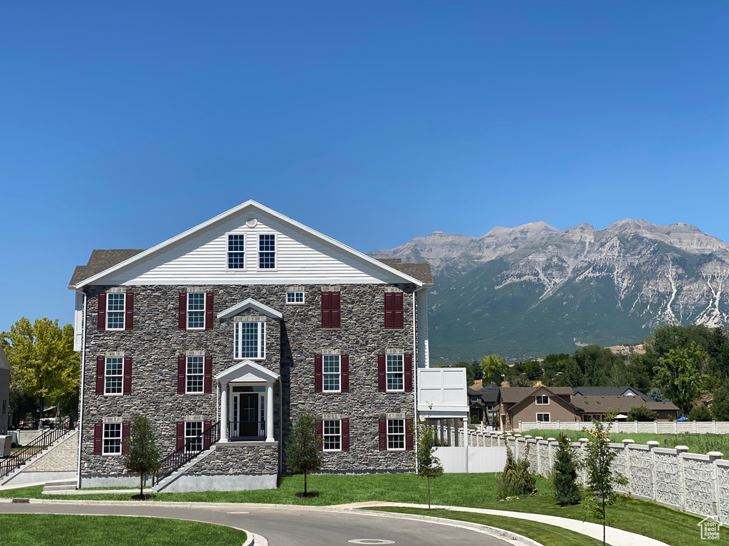 View of front facade with a front yard and a mountain view