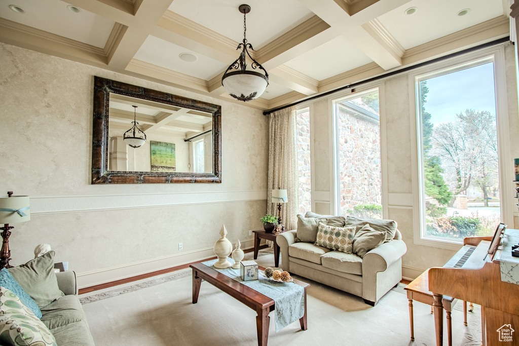 Living room featuring coffered ceiling, beam ceiling, and crown molding