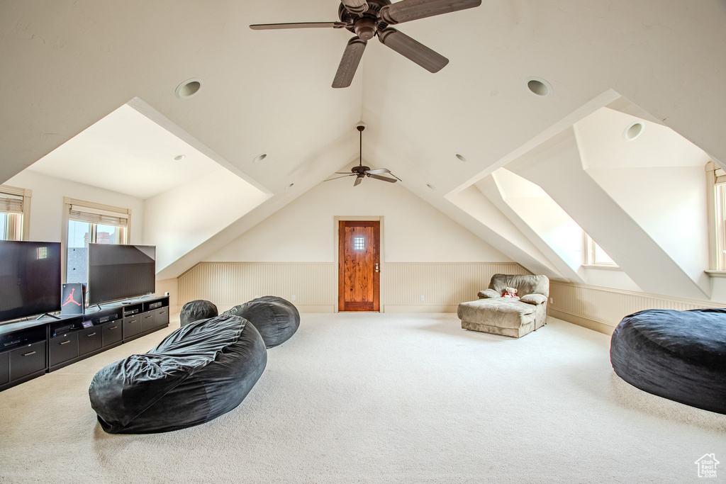 Living room with carpet, vaulted ceiling, and ceiling fan