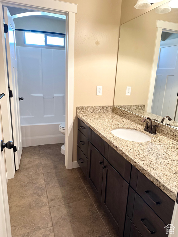 Full bathroom featuring toilet, tile flooring, shower / bathtub combination, and large vanity