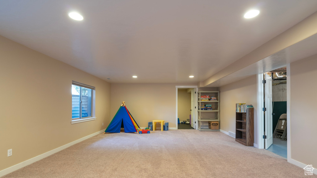 Recreation room featuring light colored carpet