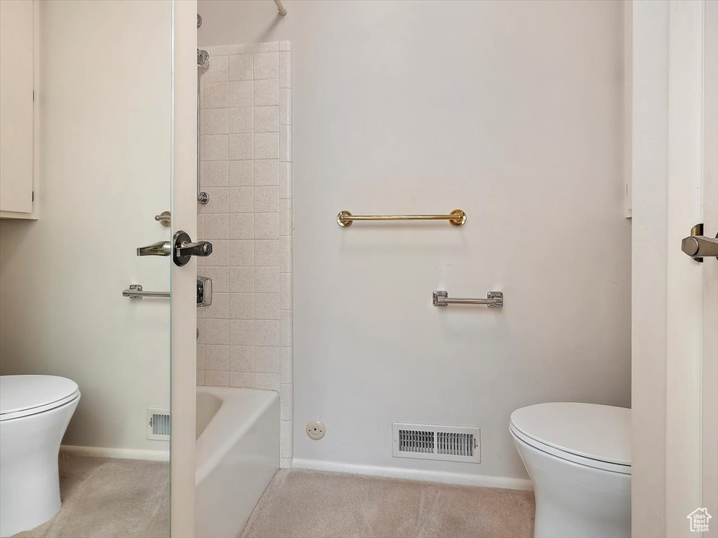 Bathroom with shower / tub combination and toilet