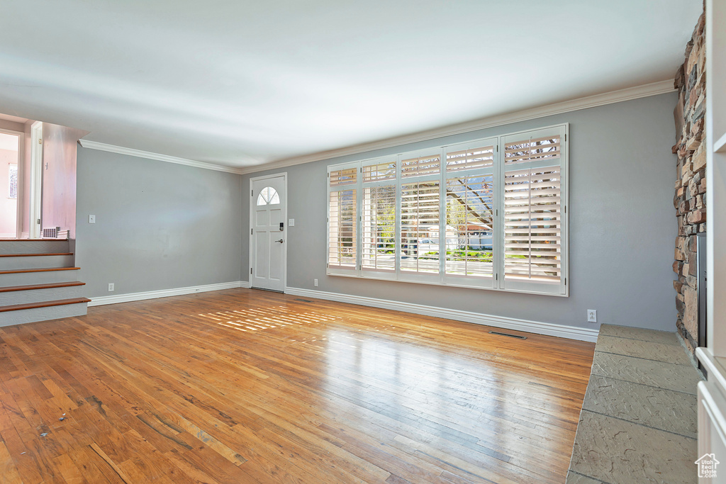 Interior space featuring crown molding and light wood-type flooring