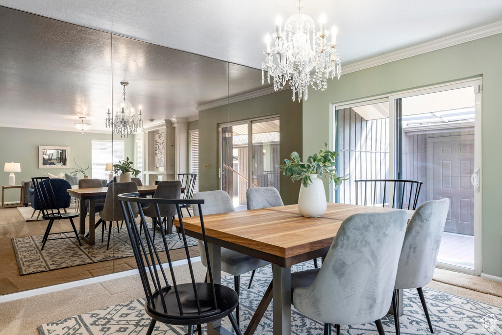 Dining space with a chandelier, ornamental molding, and a healthy amount of sunlight