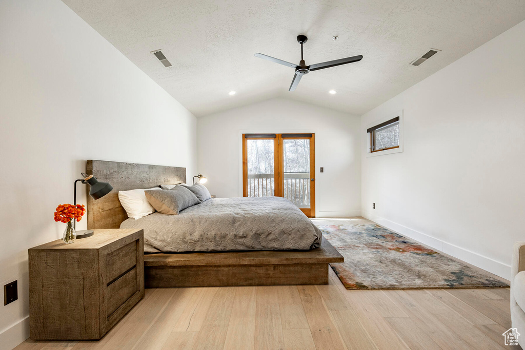 Bedroom with ceiling fan, vaulted ceiling, light hardwood / wood-style floors, and access to outside