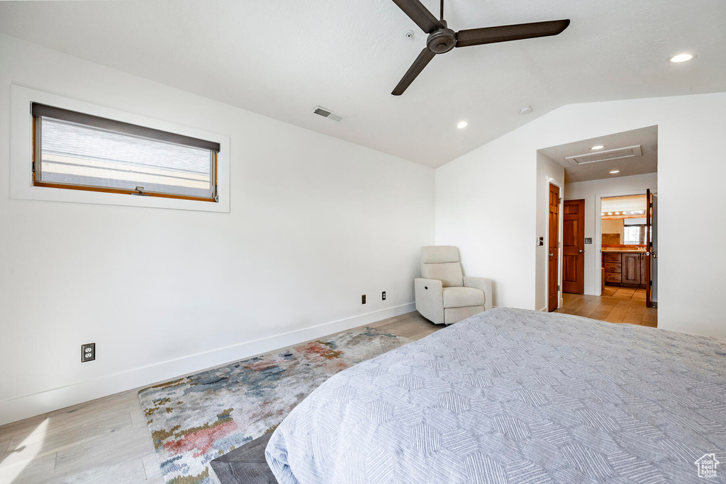 Bedroom featuring light hardwood / wood-style floors, ceiling fan, and vaulted ceiling