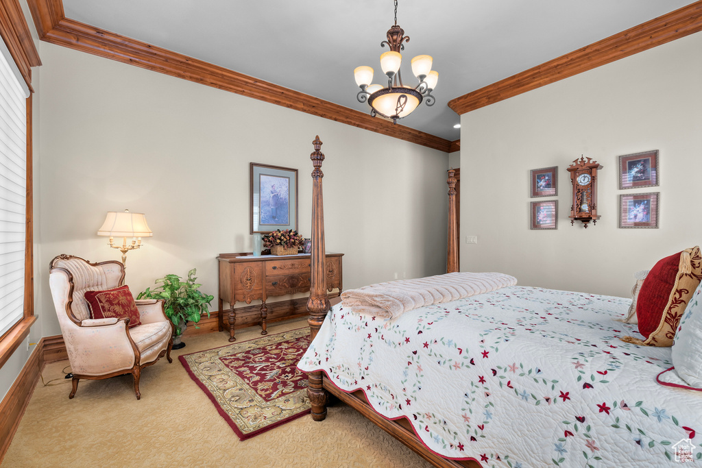 Carpeted bedroom with crown molding and a notable chandelier
