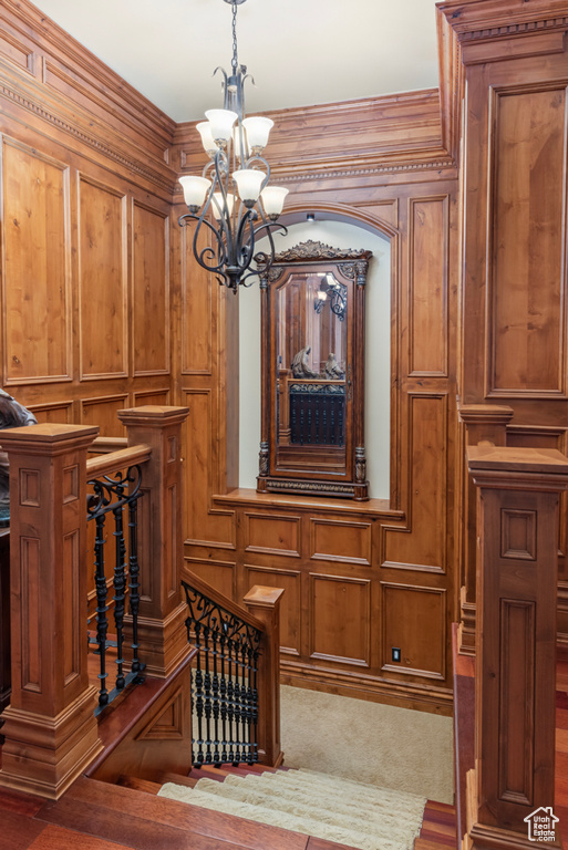 Interior details featuring dark carpet and an inviting chandelier