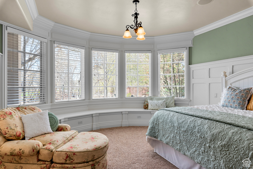 Carpeted bedroom with crown molding