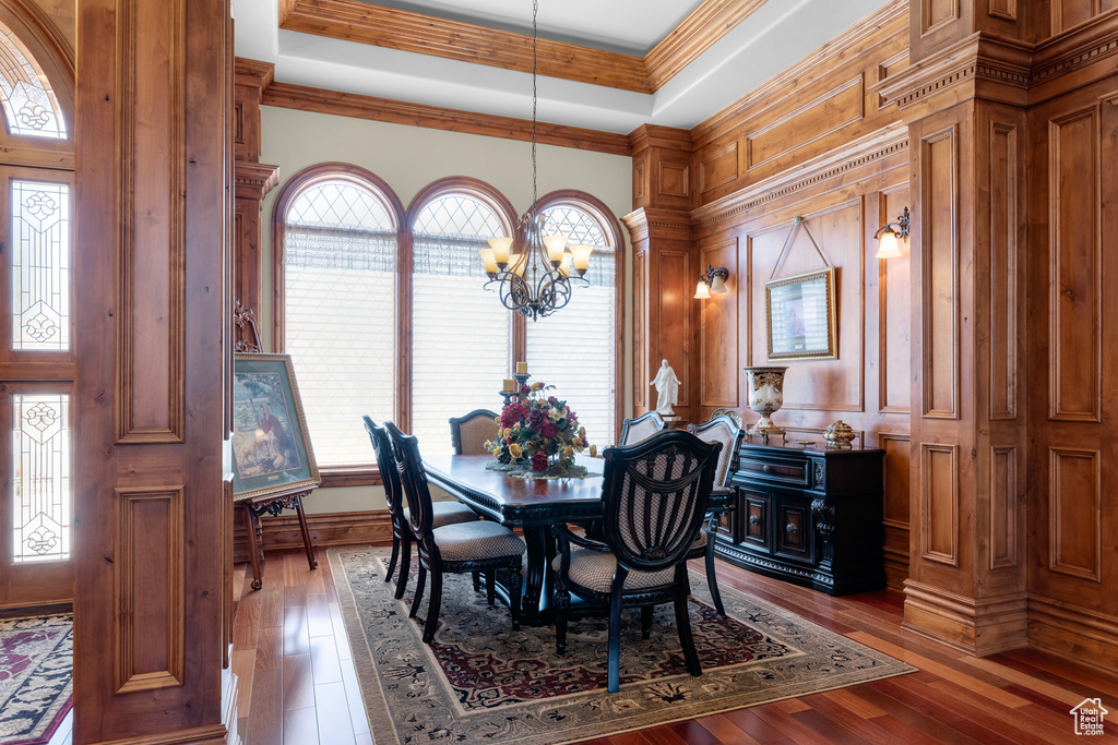 Dining area featuring plenty of natural light, dark hardwood / wood-style flooring, and a notable chandelier