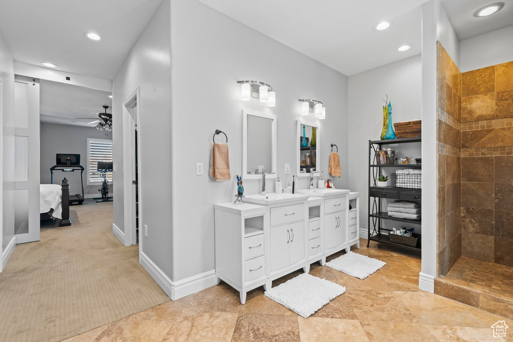 Bathroom featuring walk in shower, tile floors, ceiling fan, and double sink vanity