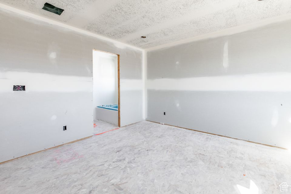 Empty room with a textured ceiling